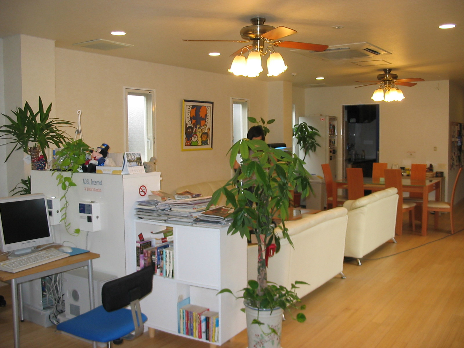 common room in hostel with sofas and desk with computer