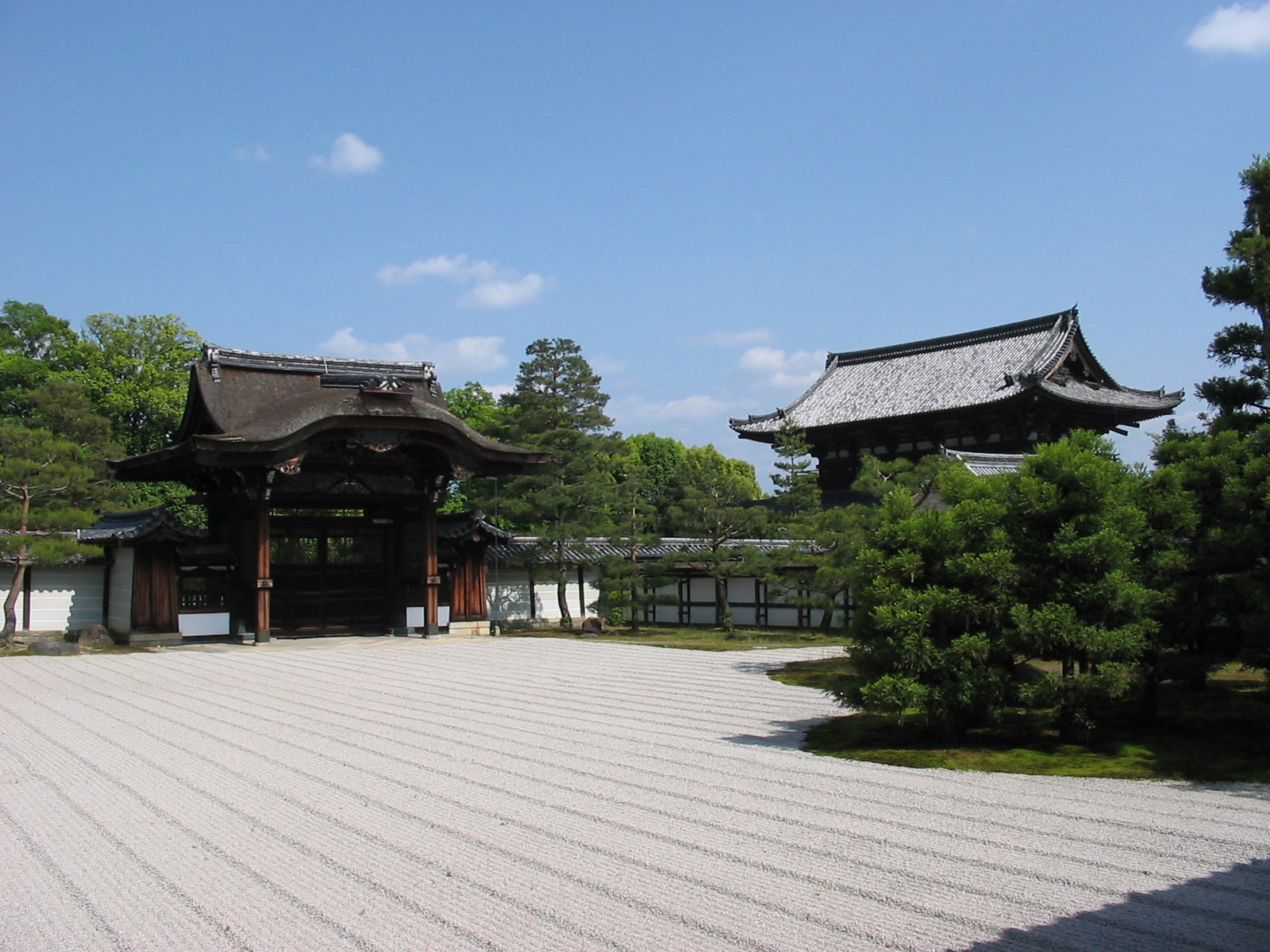 two buidlings next to zen garden of sand