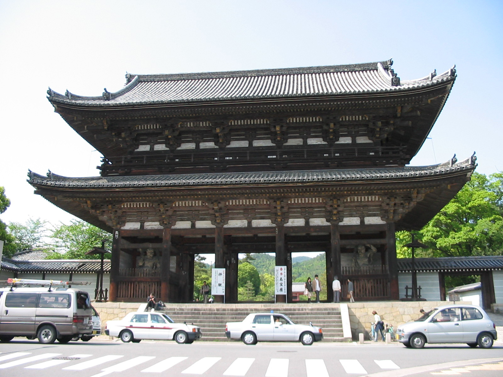 entrance to temple with cars in front