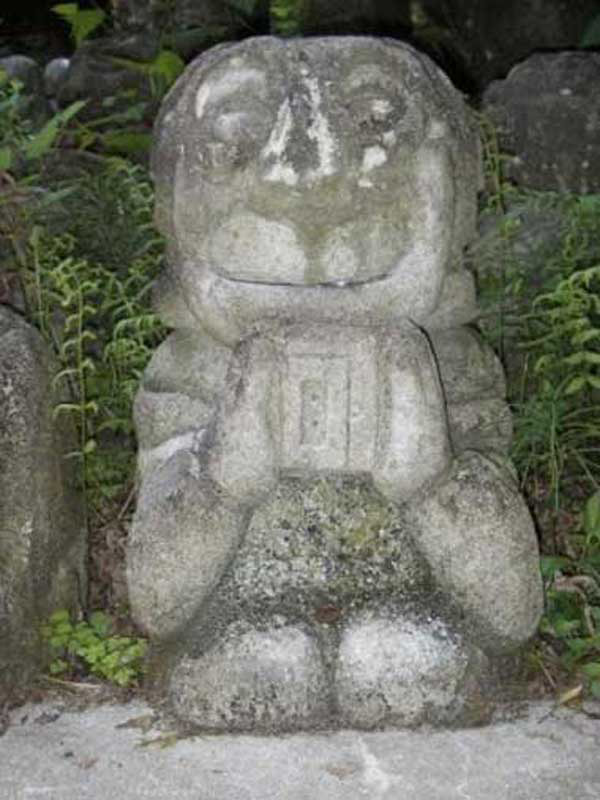 small stone statue holding a Walkman