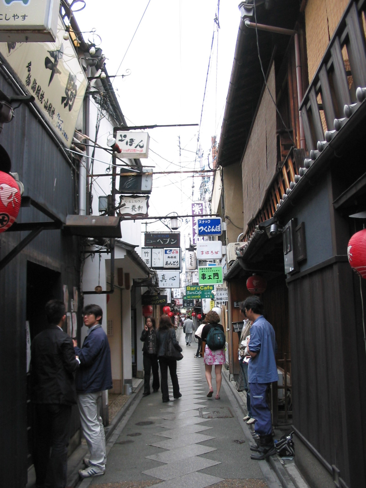 narrow street with many store signs