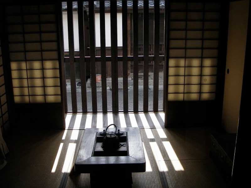 dimly lit table with teapot in house