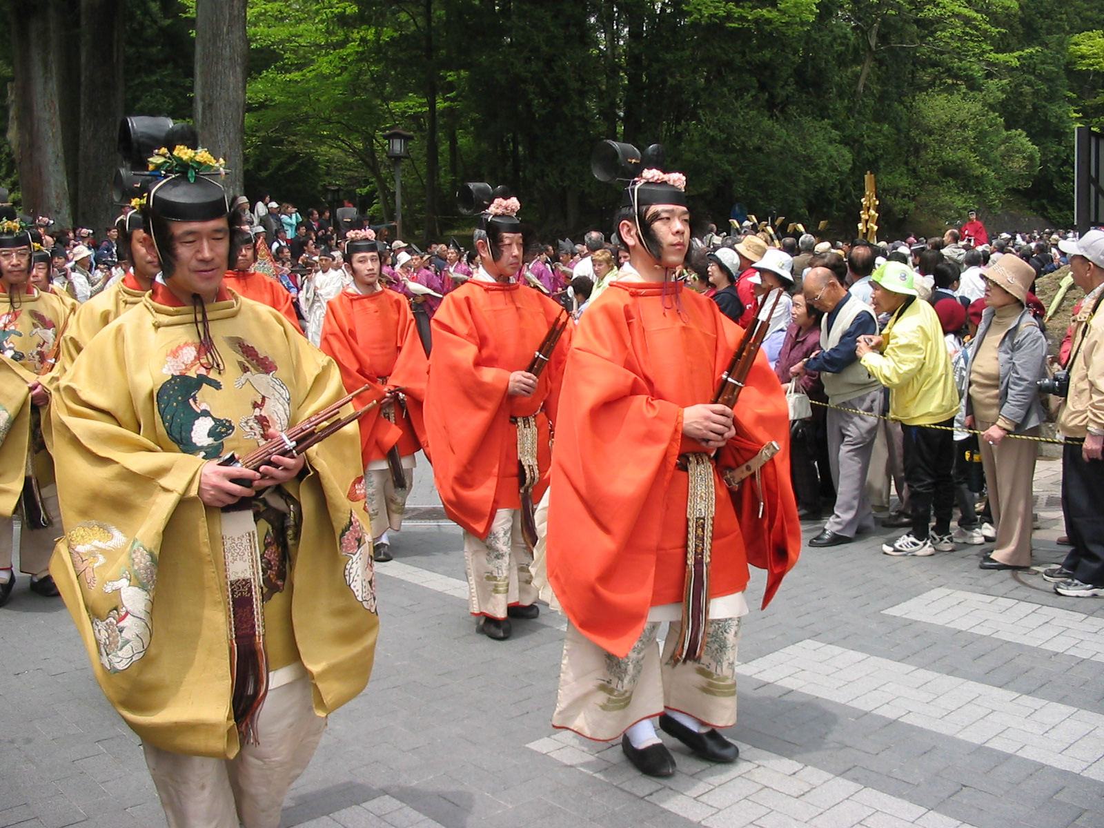 men in tradtional garb and hats with hair on the side