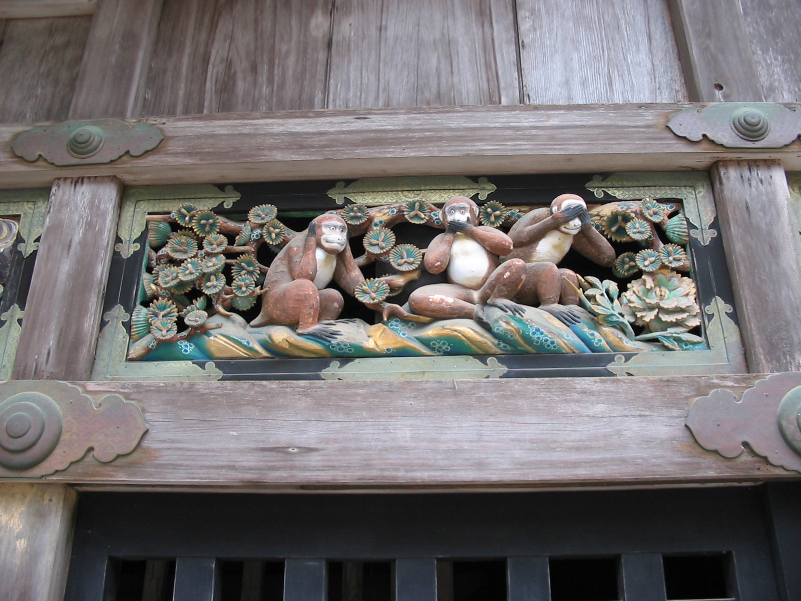 three wooden monkeys holding their ears, mouth, or eyes