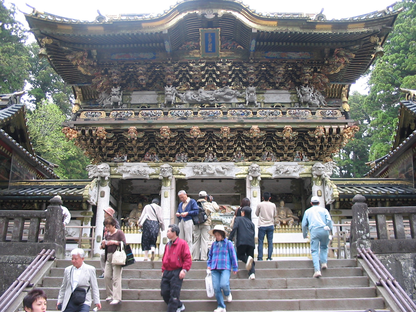 decorated wooden gate with people walking up steps to gate