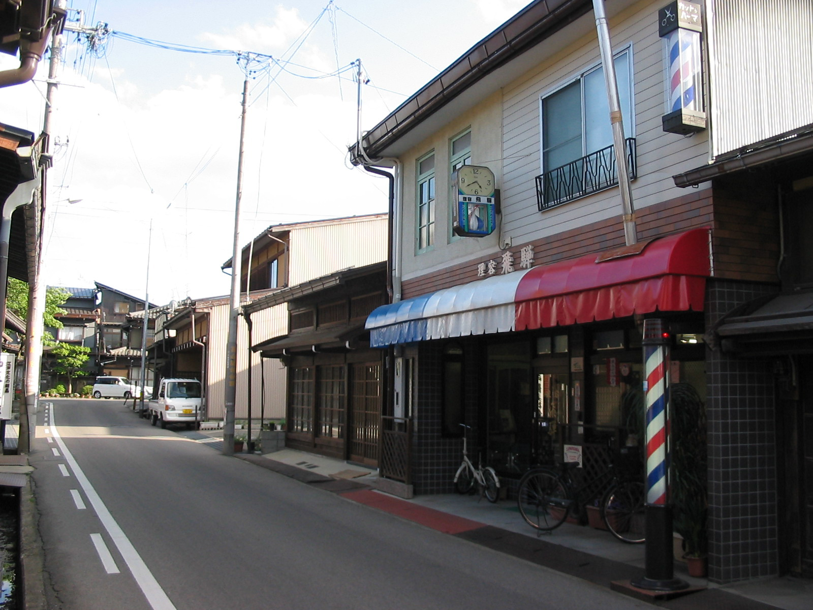 a barber pole next to a traditional building