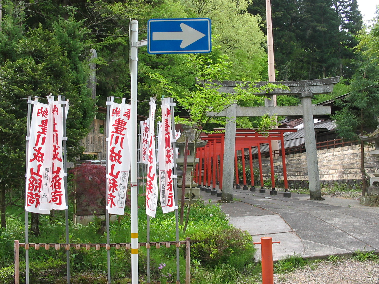 line of red torri gates with vertical flags