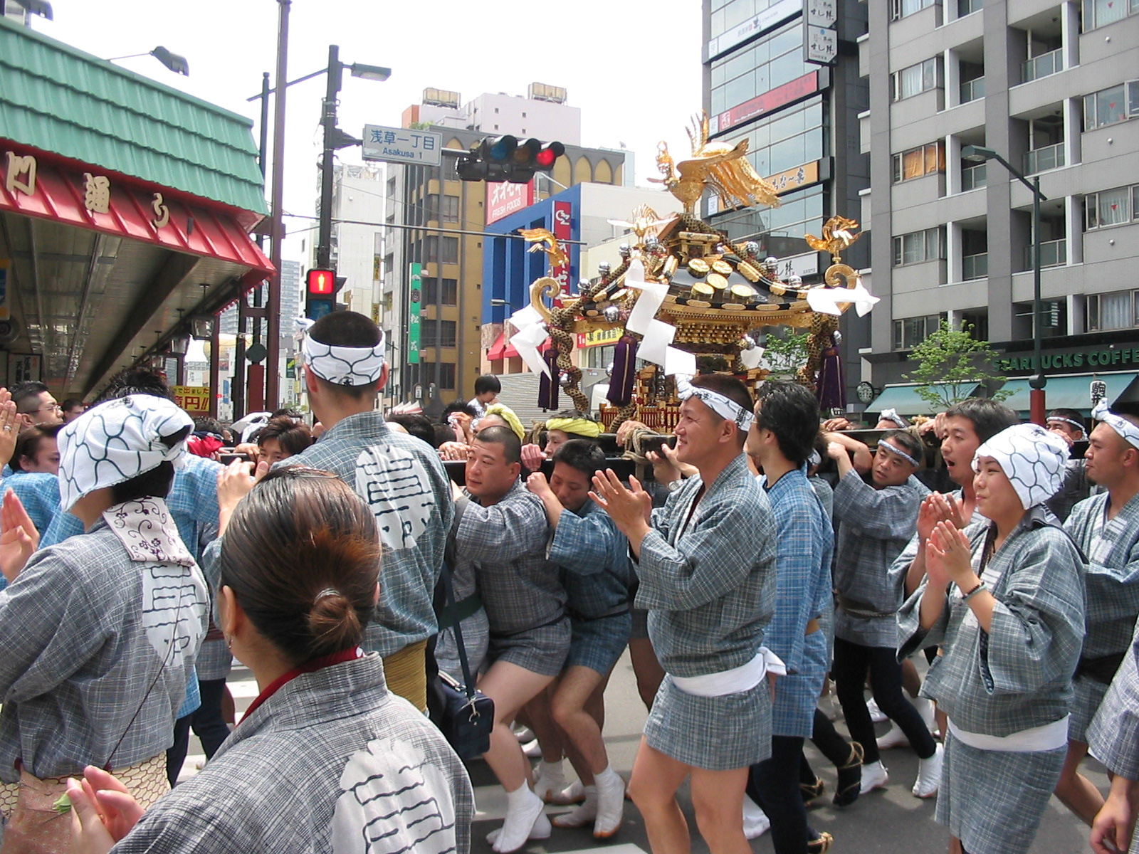 parade with men carrying golden shrine