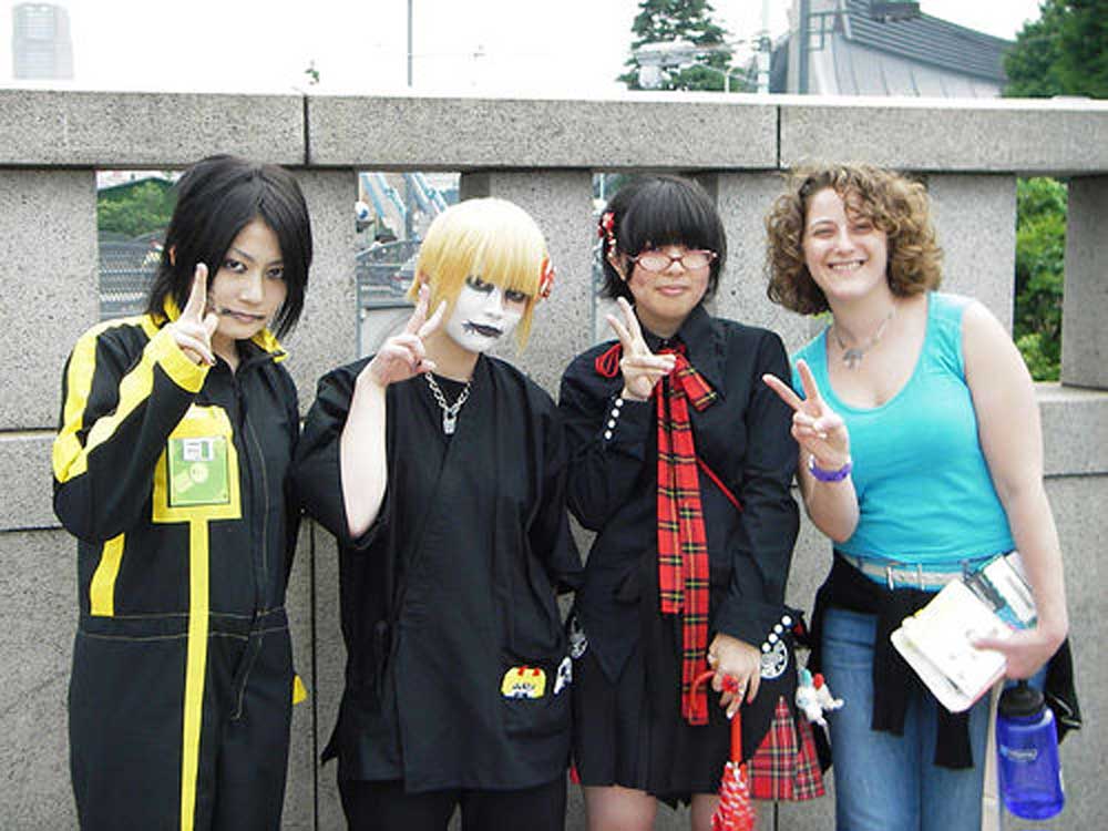 women in goth makeup giving peace sign