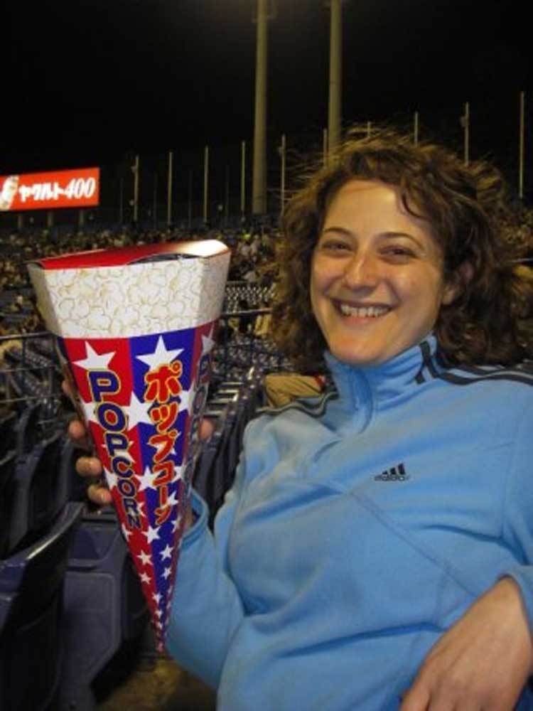 woman holding a popcorn holder that turns into a megaphone when empty