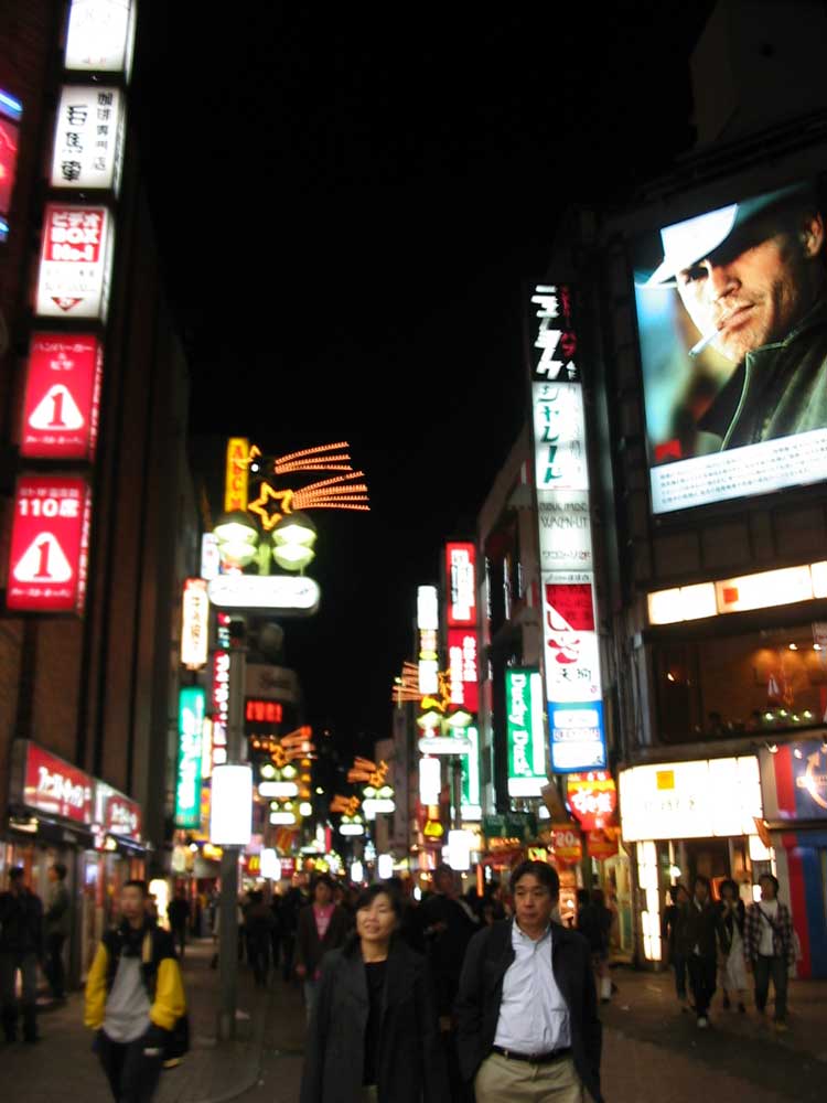 busy street at night with many neon signs